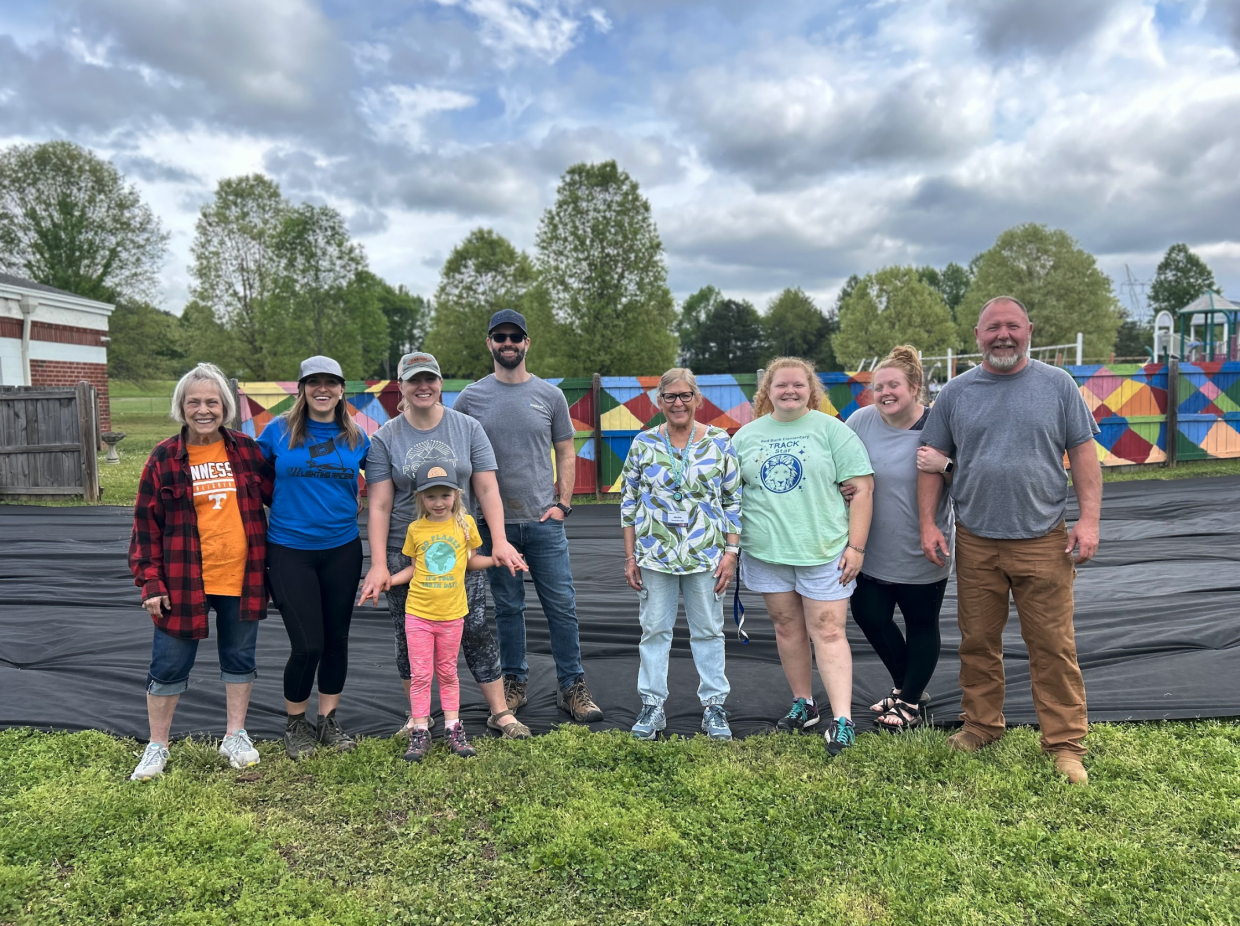 A group poses for a photo outside